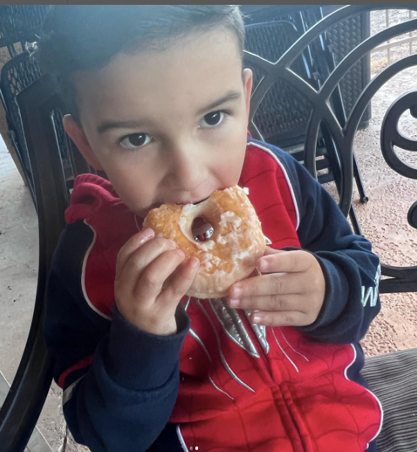 A young boy enjoying a donut
