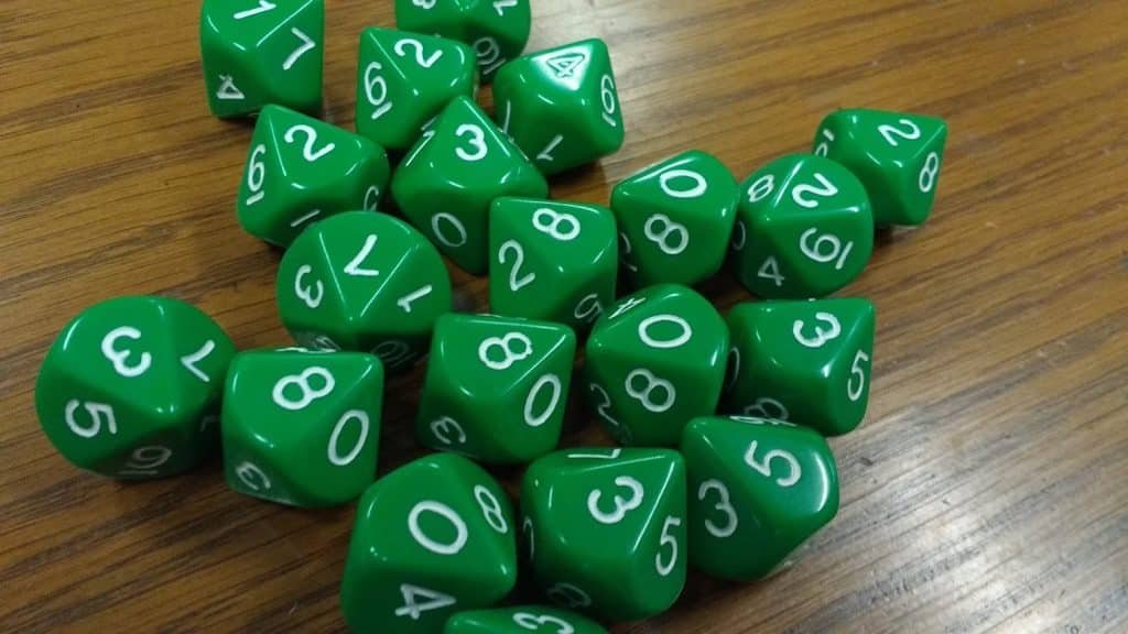 A set of green multi-sided dice used in pi day activities