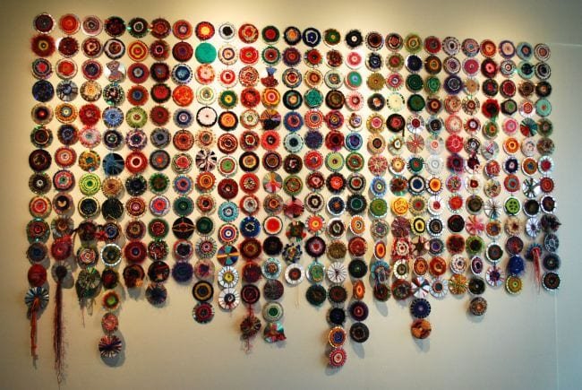 A mural of circles on a wall is shown.