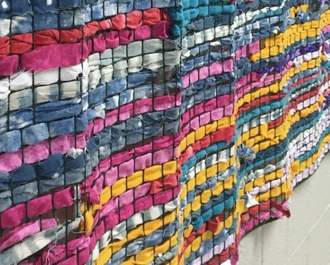 A wall of weaving is shown.
