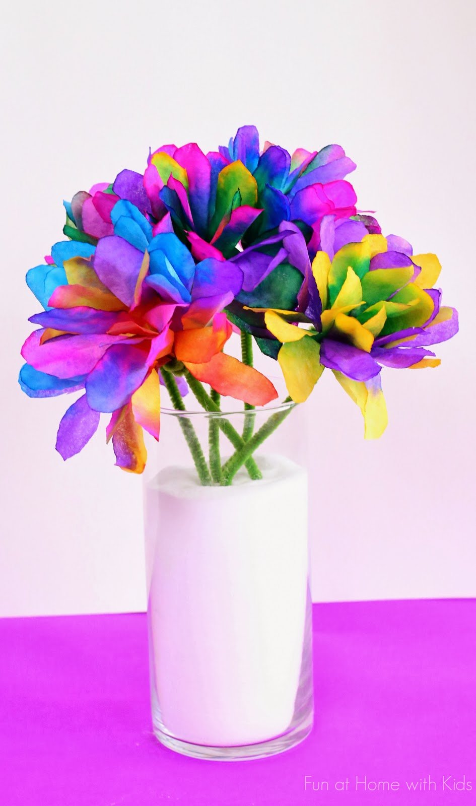 A bouquet of flowers is shown made from dyed coffee filters.