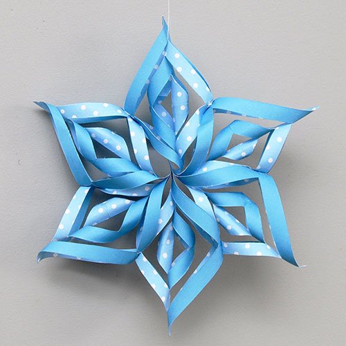 3D Paper snowflake made by cutting, folding, and rolling paper
