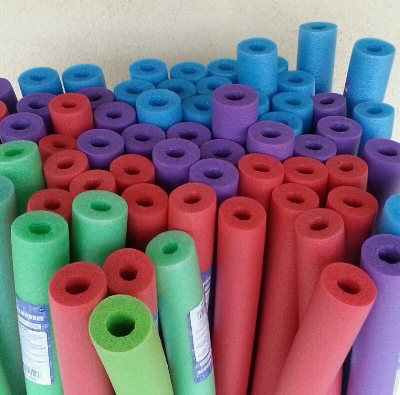 A collection of pink, purple, blue and green pool noodles