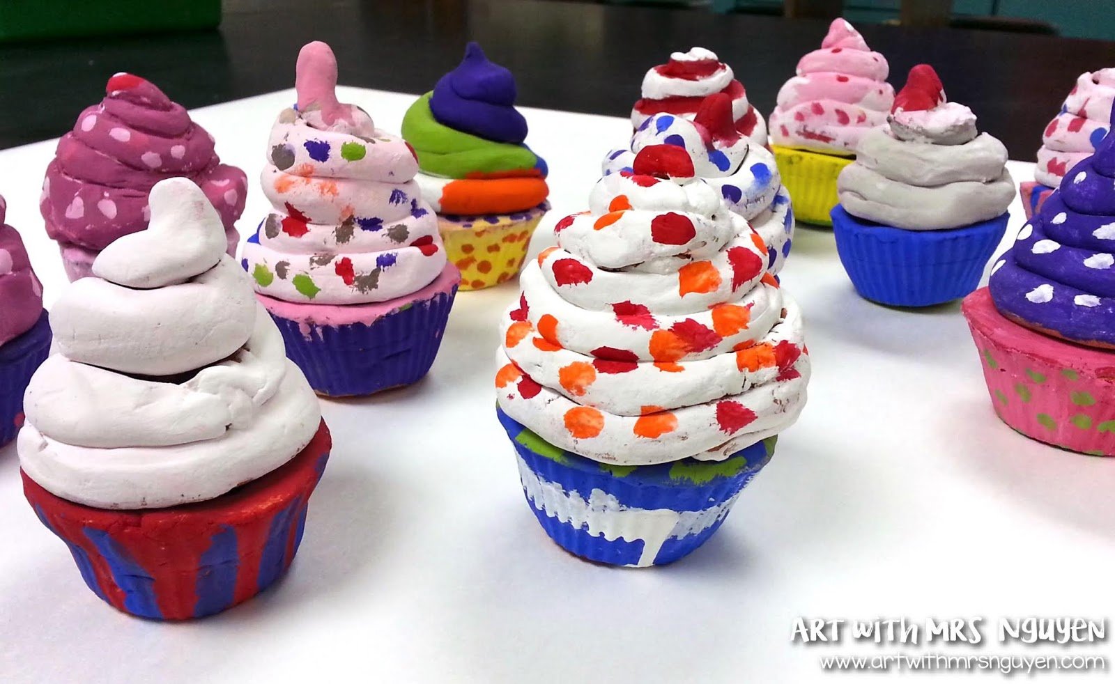 Clay cupcake pots with removable frosting lids, made as a fourth grade art project