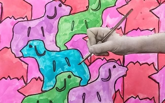 Tessellated dogs bright colors with the image of a child's handing holding a pencil pasted on top