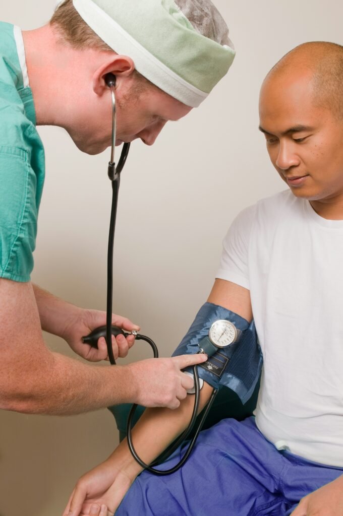 A nurse takes a man's blood pressure