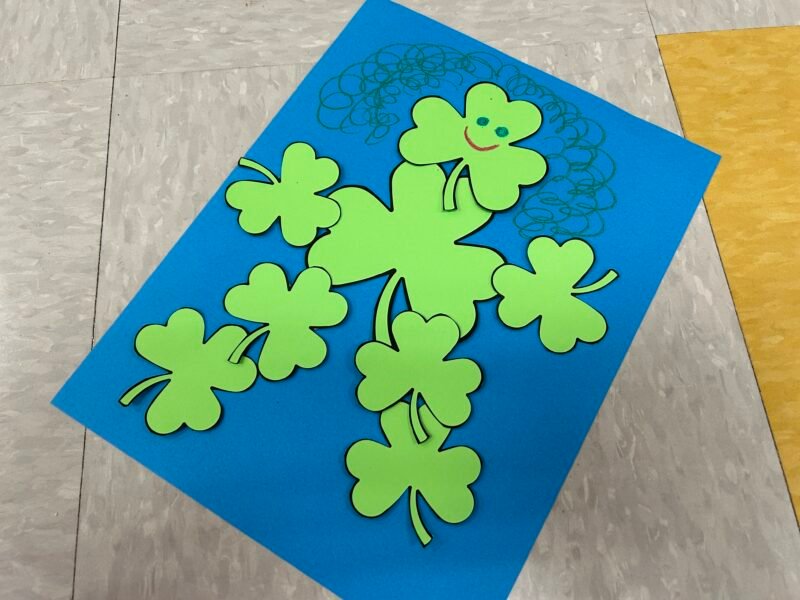 person made out of shamrock cutouts