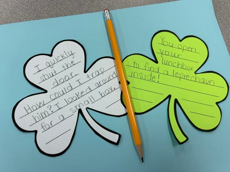 shamrock paper cutouts with story starters written on them- St. Patrick's Day activities