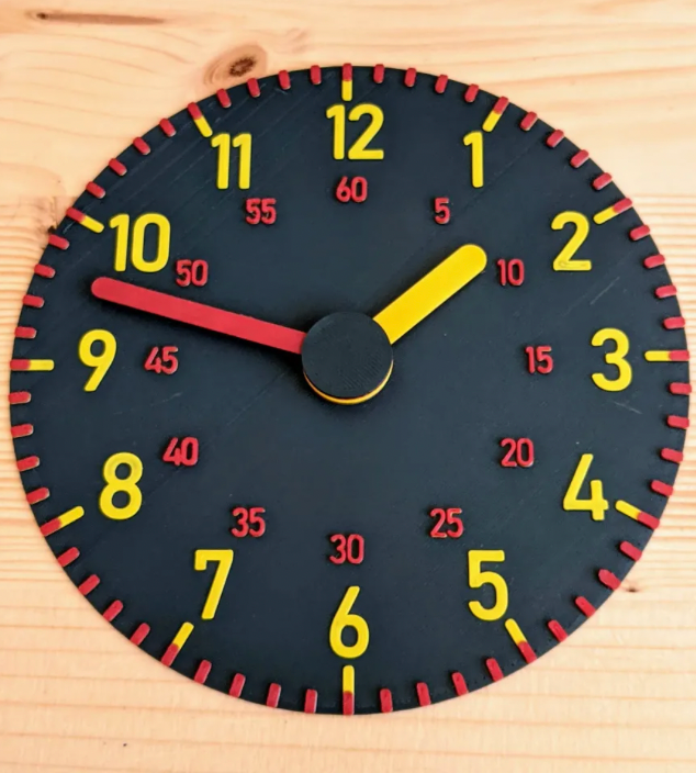 3d printed black clock with yellow letters