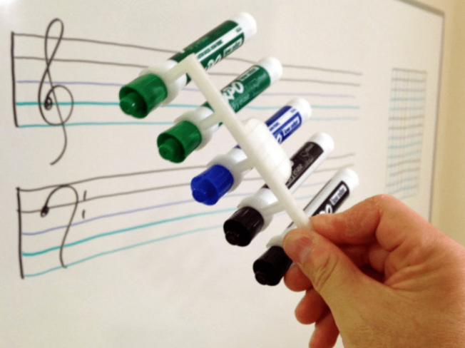 Parallel Line Drawer. 5 markers are seen being held together by a white holder as an example of 3D printing ideas