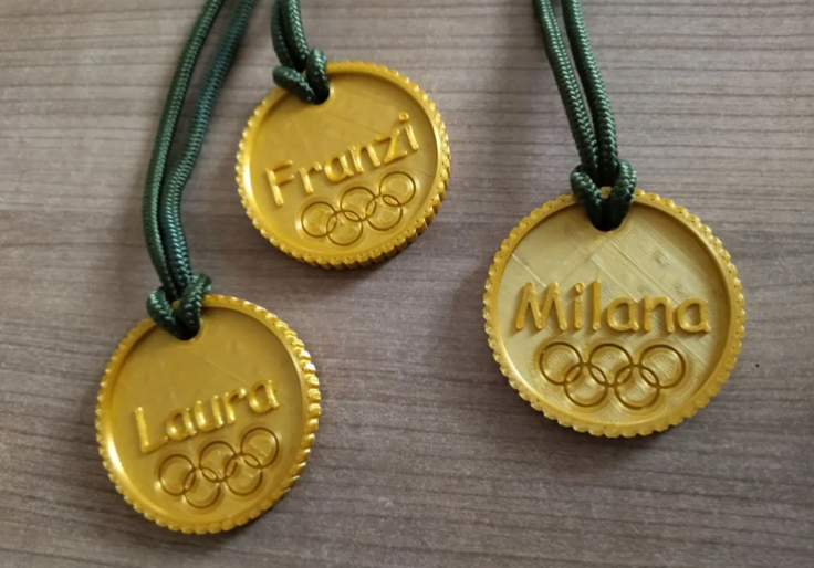Different gold medals on necklaces