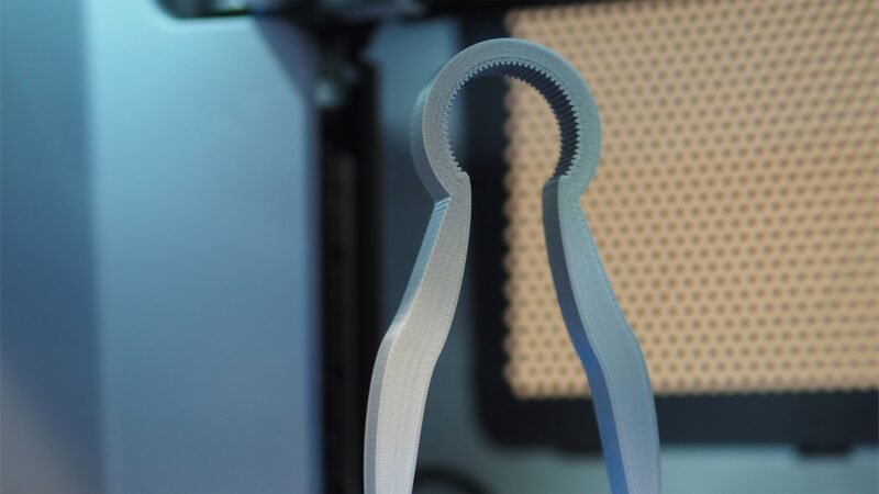 A gray bottle opener is shown as an example of 3D printing ideas