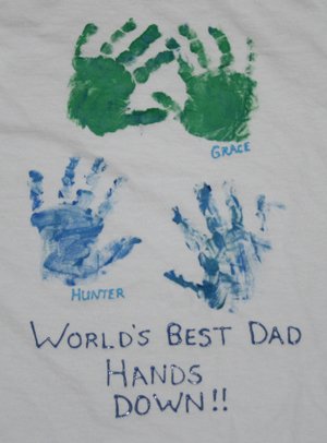 A shirt has children's fingerprints and names on it in this example of Father's Day crafts for kids.