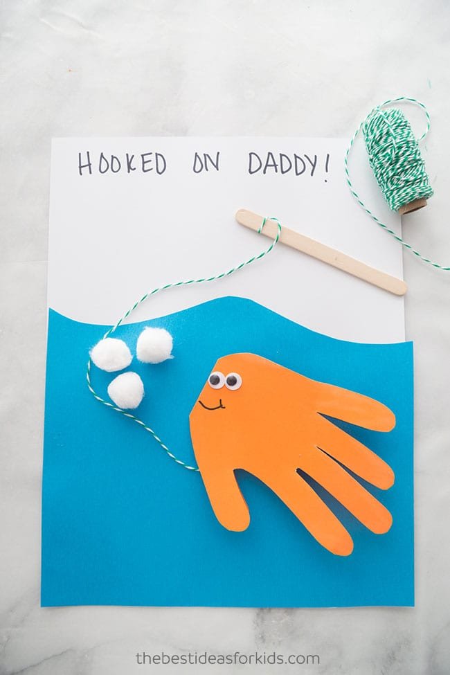 Homemade fish (made from a handprint) on a string father's day card as an example of father's day gifts for kids