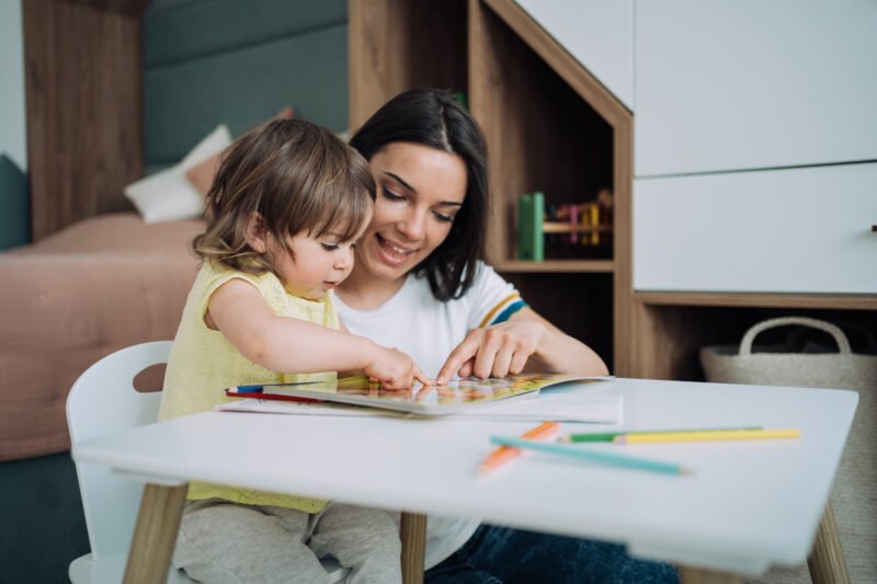 Shot of a little girl sitting at a table and coloring in a coloring book