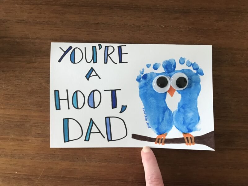 Two blue footprints are pieced together with googly eyes to look like an owl. Text reads You're a Hoot Dad.