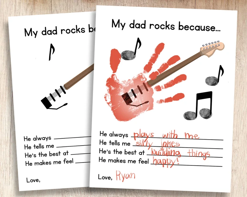 Two pieces of paper are shown. One has a handprint turned into a guitar on it. It says My Dad rocks because...