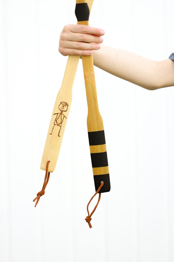 Wood back scratchers are decorated with drawings and strips of tape