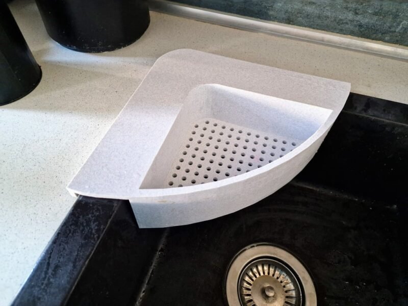 A sink is shown with a small white strainer in the corner in this example of 3D printing ideas.