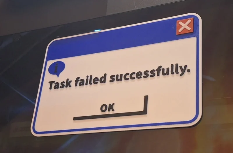 A white sign says Task Failed Successfully. It's made to look like a website screen.