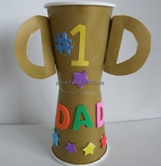 Two coffee cups are made into a trophy that has stickers that say #1 Dad