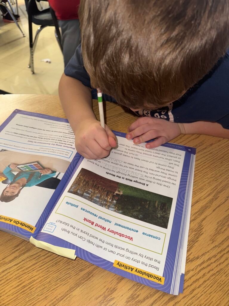 boy writing in workbook