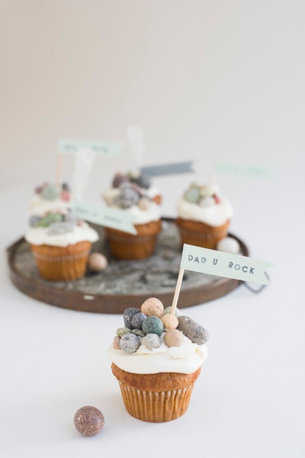 Cupcakes with edible rocks on them that say Dad U Rock.