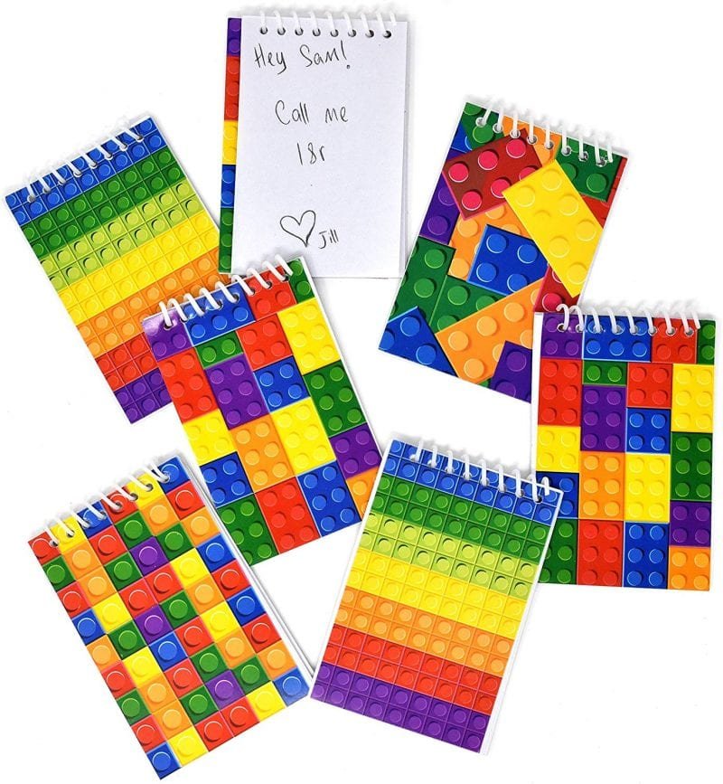 Small spiral notepads with covers that look like colorful LEGO blocks
