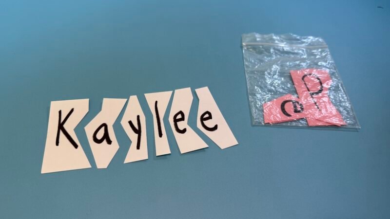 Name Kaylee written on paper and cut into strips by letter