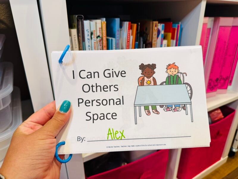 social-emotional learning activities social stories mini book printable that teacher is holding
