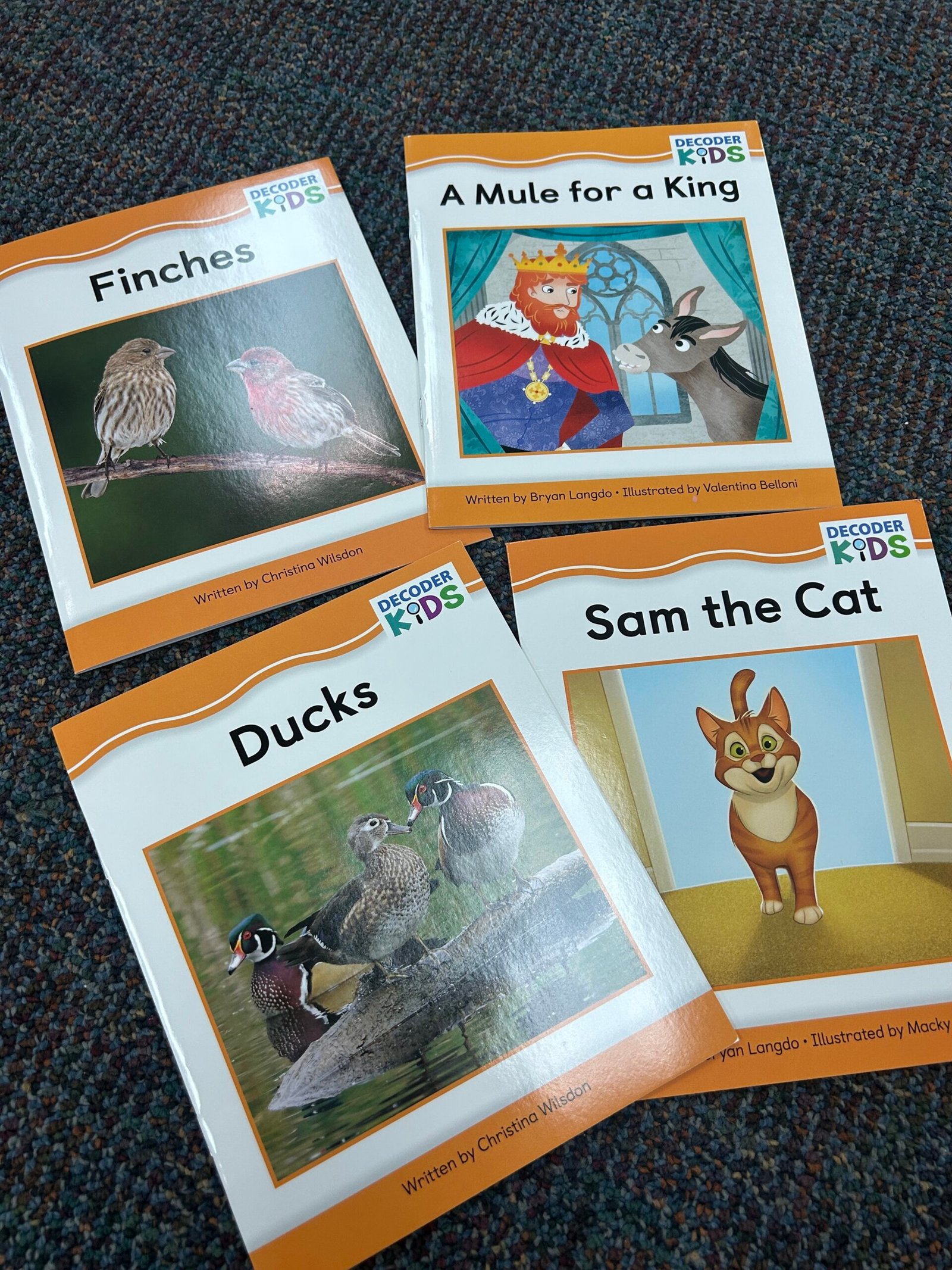 Pictures of four books from Decoder Kids Phonics Kits