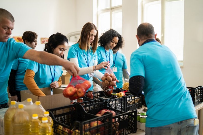 Students and adults volunteering in a food pantry