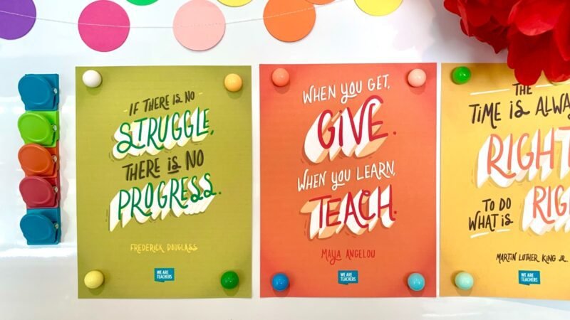 Multiple posters on a whiteboard.