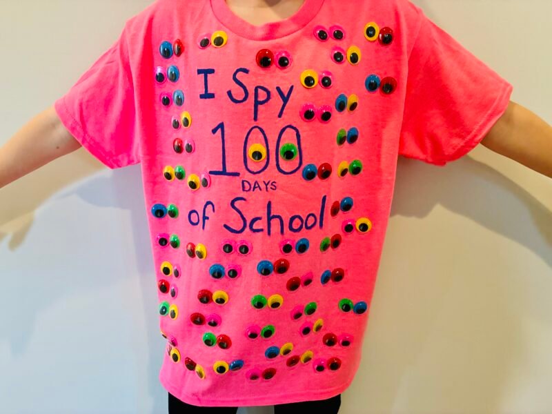 a student wearing a neon pink shirt with the words 