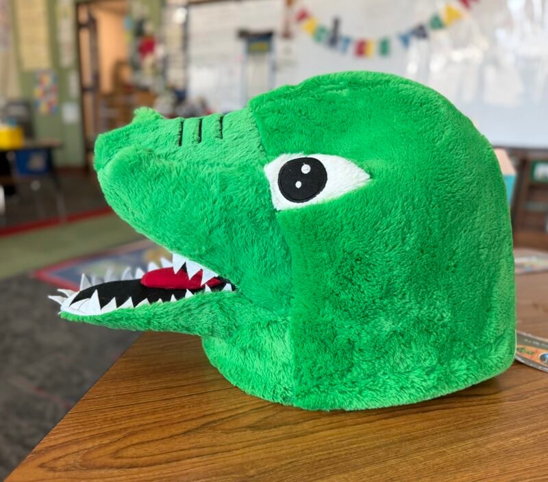 dinosaur head alone in classroom