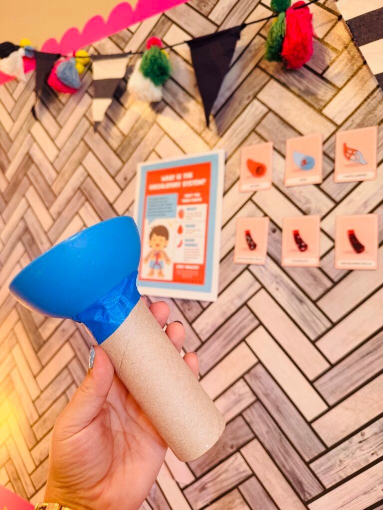 an image of a student created stethoscope made out of a paper towel roll 