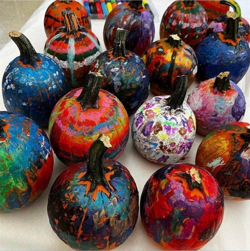 Pumpkins painted using Kwik Stix paint sticks in a variety of designs