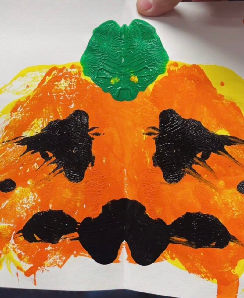 Pumpkin created by painting one half of the page and folding it over 