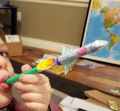an image of a student creating a rocket out of a straw