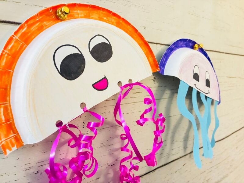 paper plate jellyfish ocean craft hanging on a bulletin board