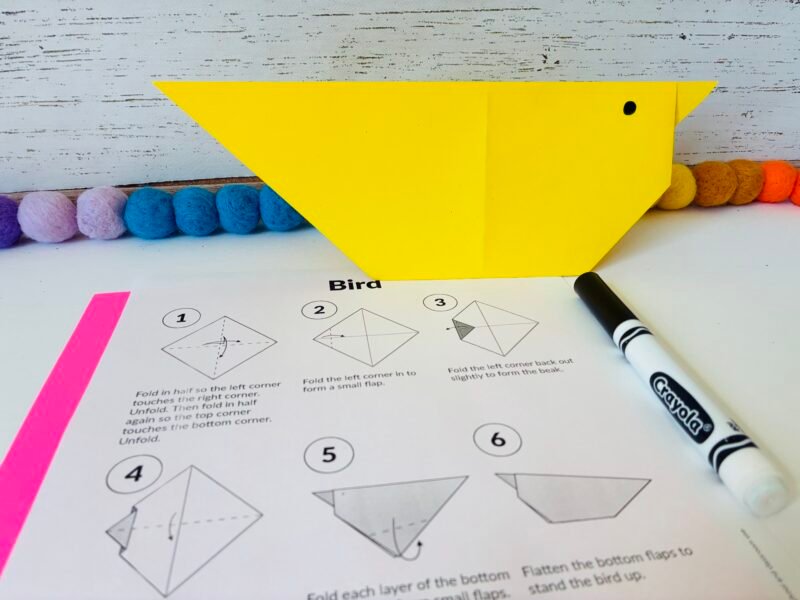 a summer craft for kids that involves creating a bird out of origami