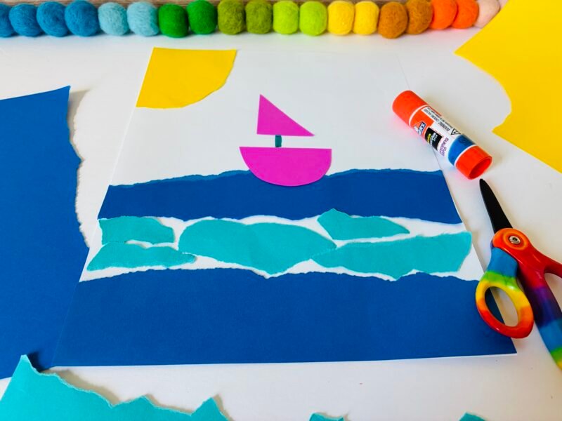 a summer craft for kids that involves using torn up paper to create an ocean scene