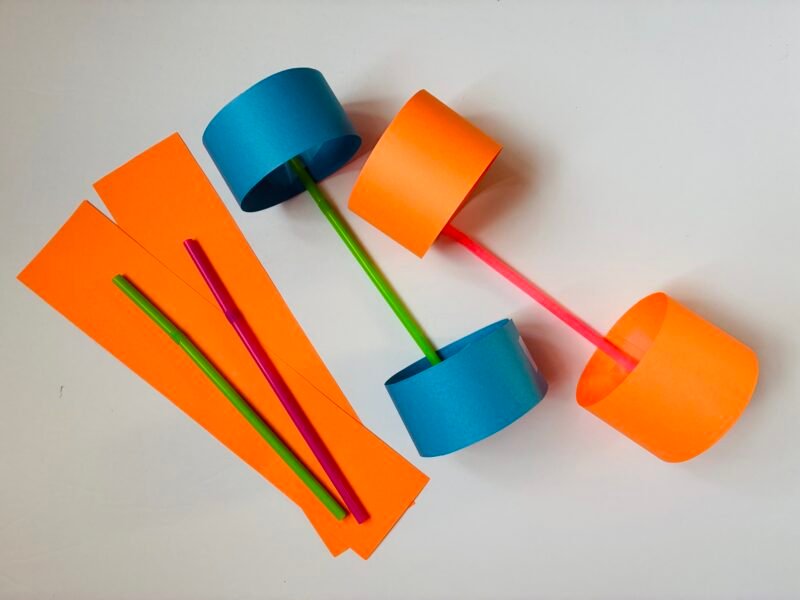 an image of strips of paper and straws to construct a flying object